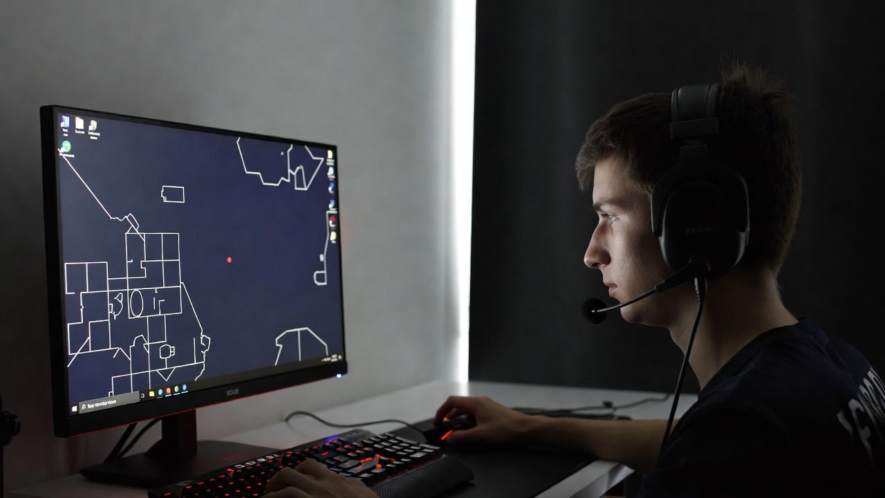 Esports player practicing aim training map in a dimly lit gaming setup